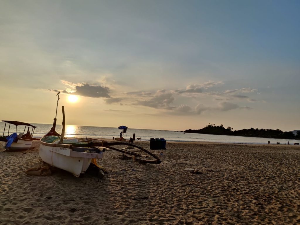 Boats along the beach during sunset