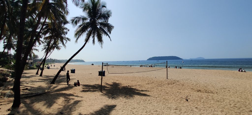 Beach and sand with a volleyball net.