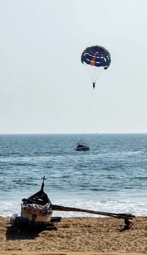 Someone paragliding on the beach